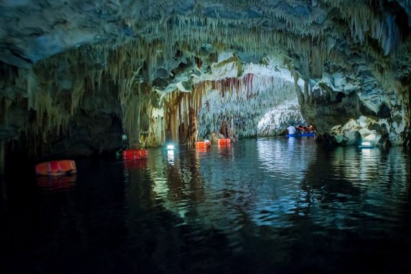 Diros Caves, Laconia: Impressive underground caves featuring stalactites, stalagmites, and an accessible river for guided boat tours