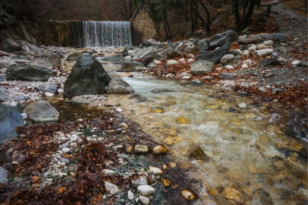 River with colored stones and hot springs in Loutra Pozar
