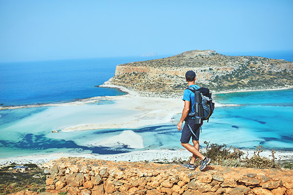 Back,View,Of,Hiker,With,Small,Backpack,On,The,Trail