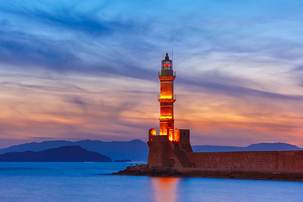 Venetian harbour and lighthouse at sunset in Chania