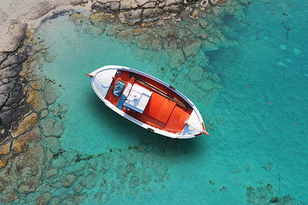 Traditional fishing boat docked in paradise bay of Elafonisi