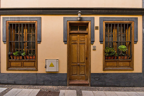 Traditional canarian mansion with wooden door and windows with bars in San Cristobal de La Laguna, Tenerife
