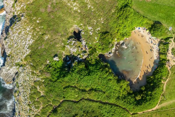 Playa de Gulpiyuri, Llanes, Asturias: a unique inland beach, declared a Natural Monument. Famous for being a "sinkhole beach" with a series of underground tunnels.