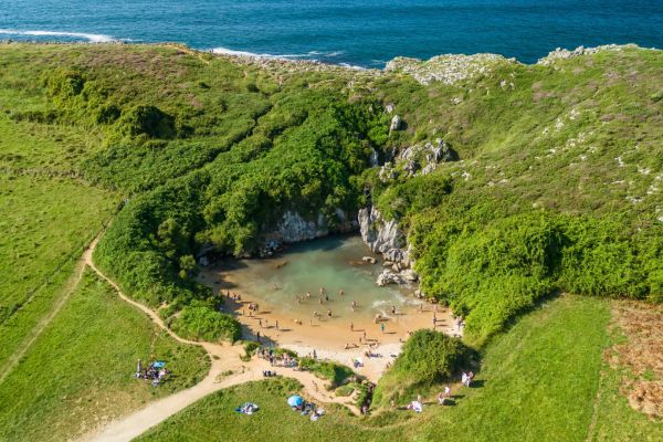 Playa de Gulpiyuri, Llanes, Asturias: a unique inland beach, declared a Natural Monument. Famous for being a "sinkhole beach" with a series of underground tunnels.