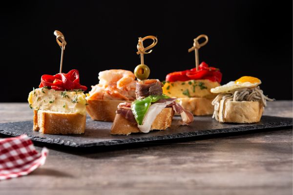 Pintxos: High-end appetizers often served on a slice of bread, ranging from the simple "Gilda" (anchovy, olive, and pepper) to elaborate warm miniature dishes.